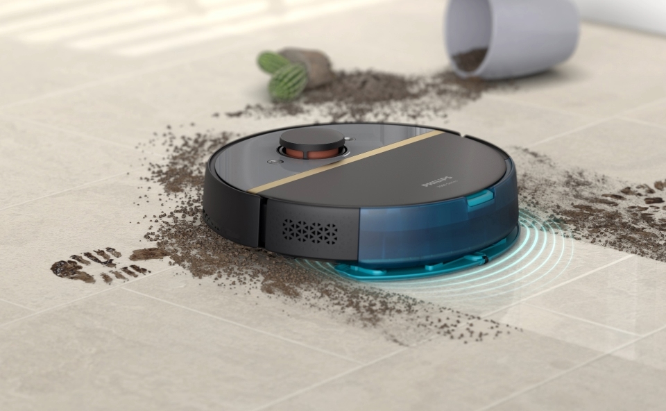 Czarny robot mopujący czyści brudne płytki w kuchni.