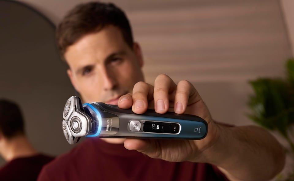 Mężczyzna trzymający maszynkę do golenia i9000 Prestige SkinIQ