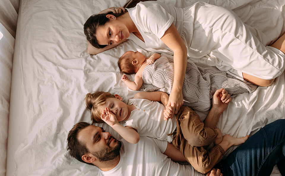 Rodzice trzymający w ramionach swoje dziecko